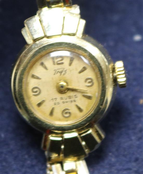 A ladys 14ct gold wrist watch, on a gilt metal bracelet.